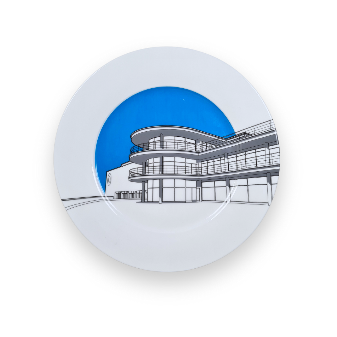 DLWP decorative white plate with a blue background and grey drawing of De La Warr Pavilion