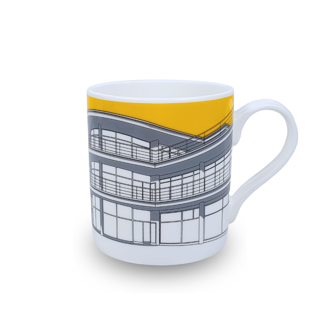 White mug with grey illustration of De La Warr Pavilion with a yellow background