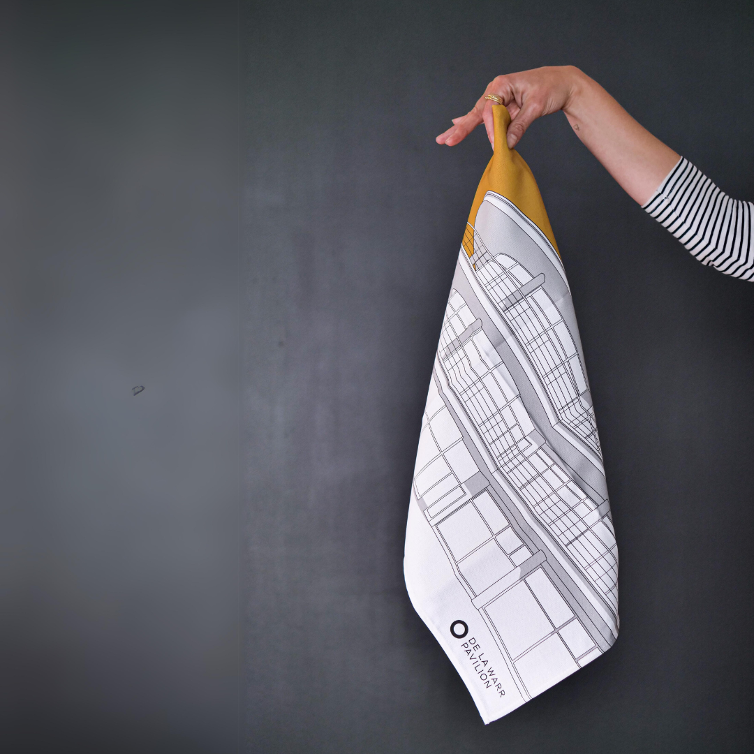 Hand holding a mustard yellow tea towel