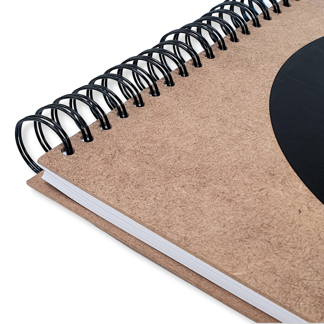 close up of DLWP square sketchbook, brown cover with large black DLWP roundel