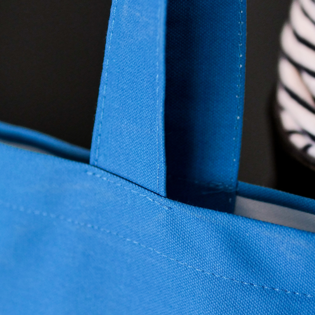 close up of Blue canvas bag with grey illustration of De La Warr Pavilion