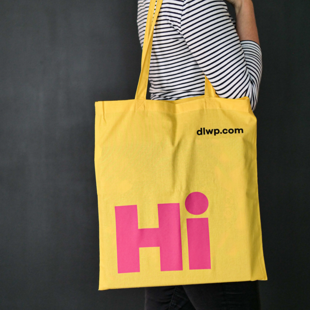 Bright yellow tote bag with the word 'Hi' in large pink font