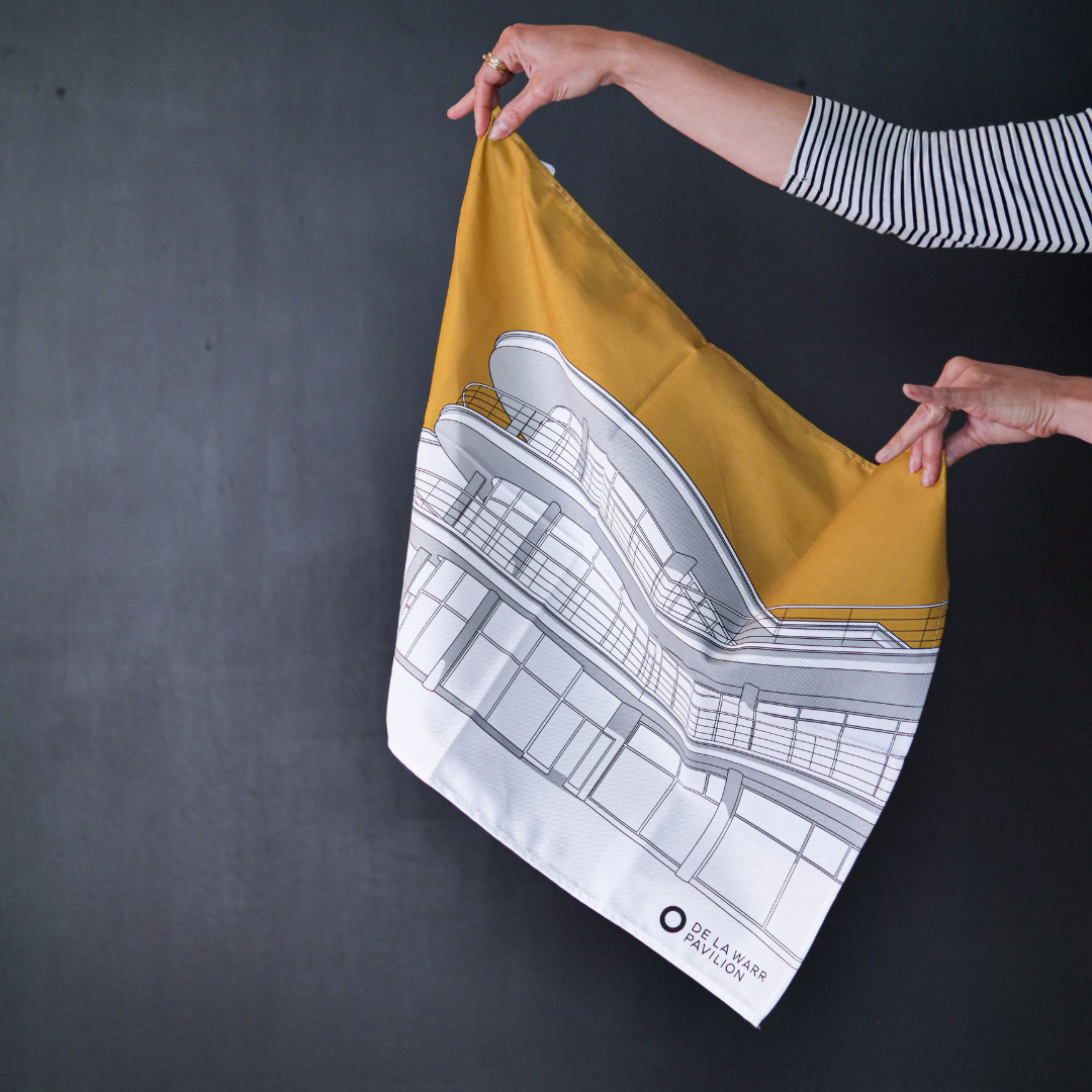 Hands holding a mustard yellow tea towel