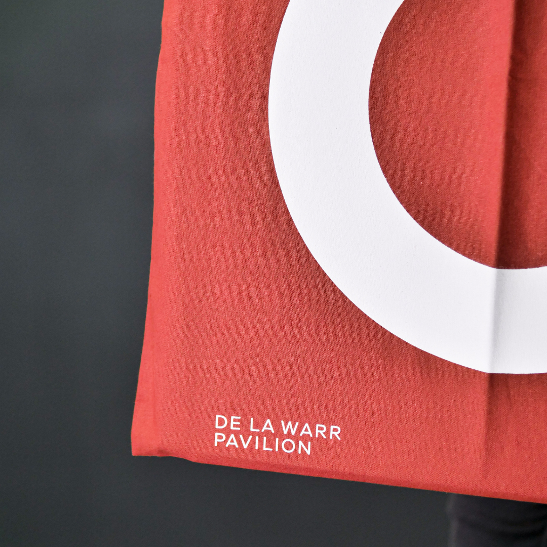 close up of Rust colour tote bag with large white DLWP roundel