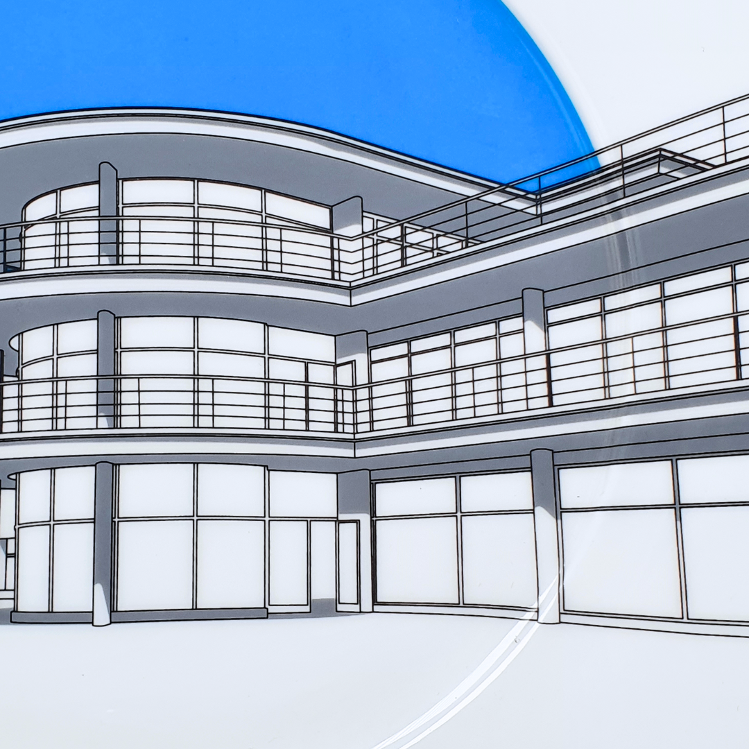 Close up of DLWP decorative white plate with a blue background and grey drawing of De La Warr Pavilion