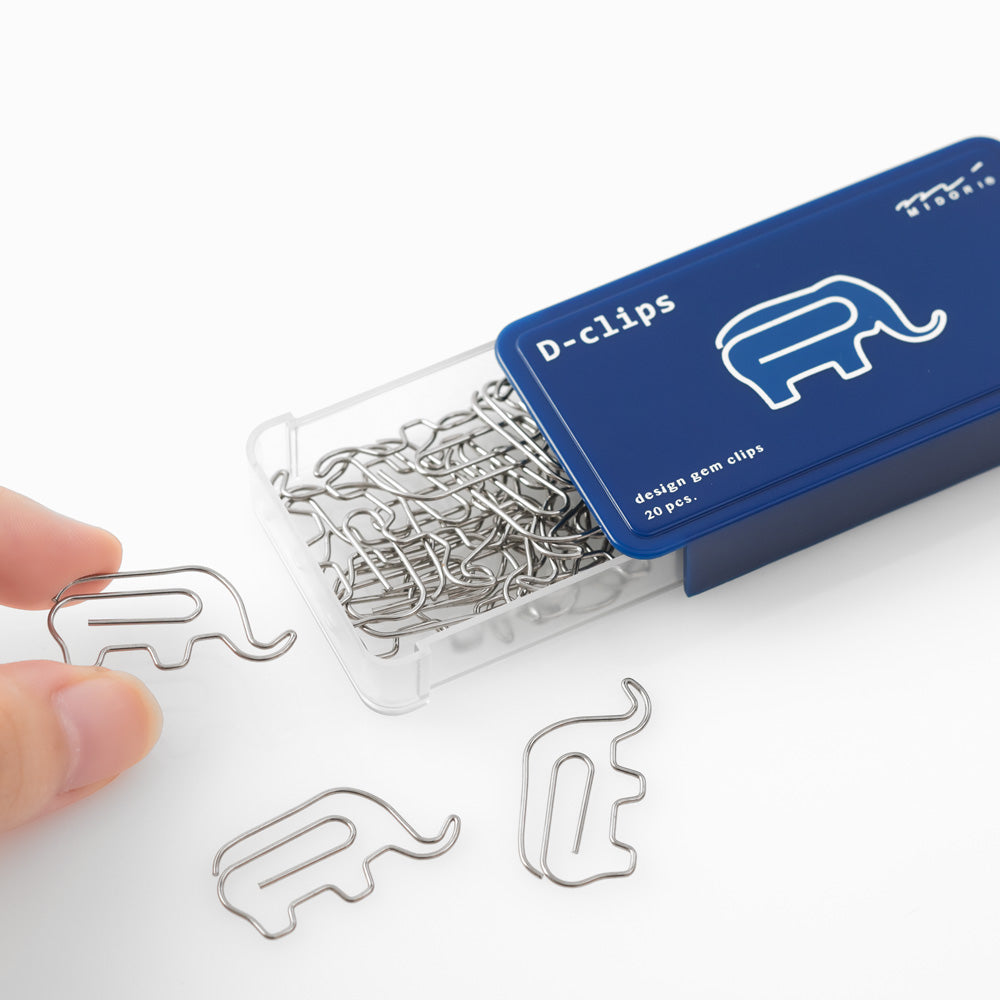 Elephant shaped paper clips in slide-open navy blue box.