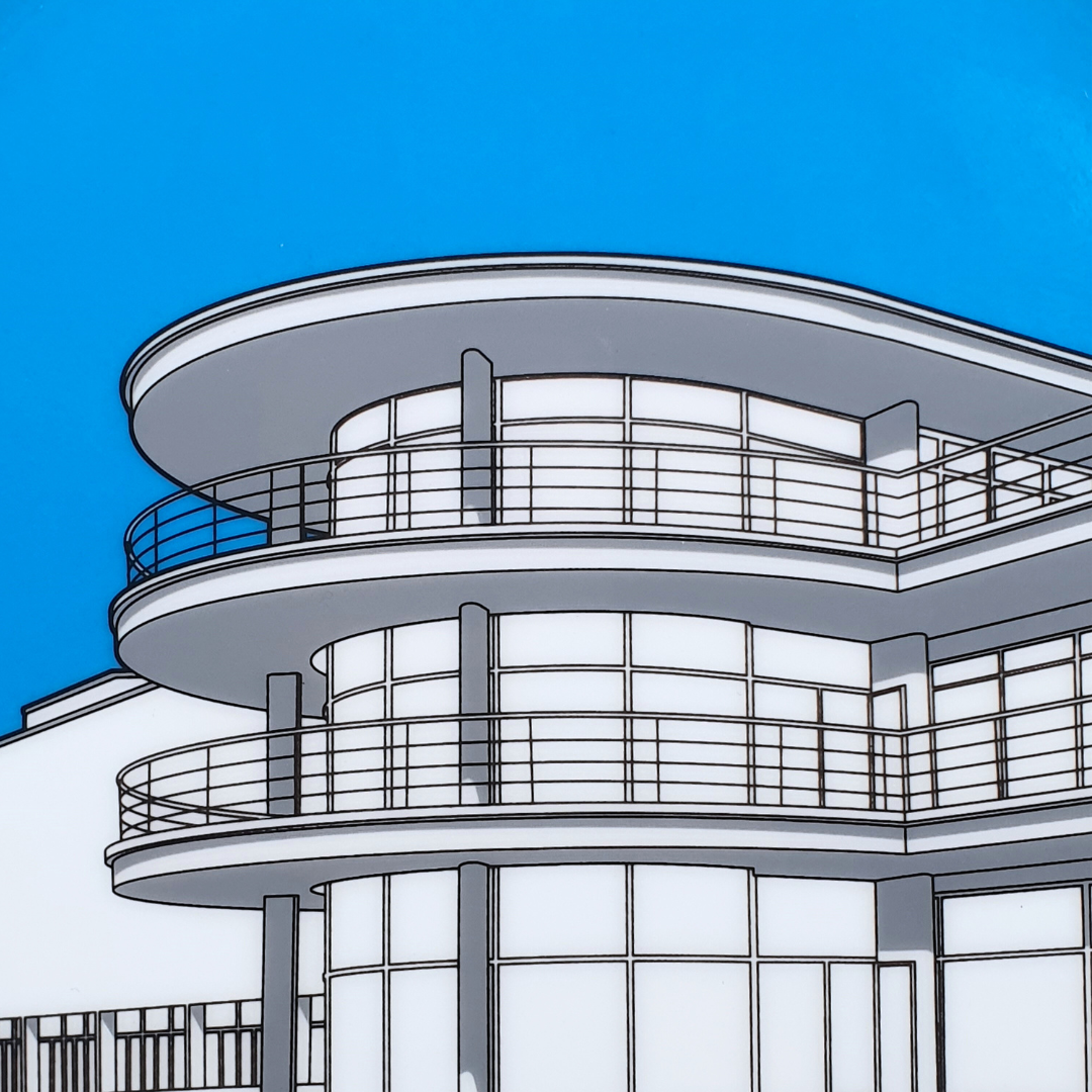 Close up of DLWP decorative white plate with a blue background and grey drawing of De La Warr Pavilion