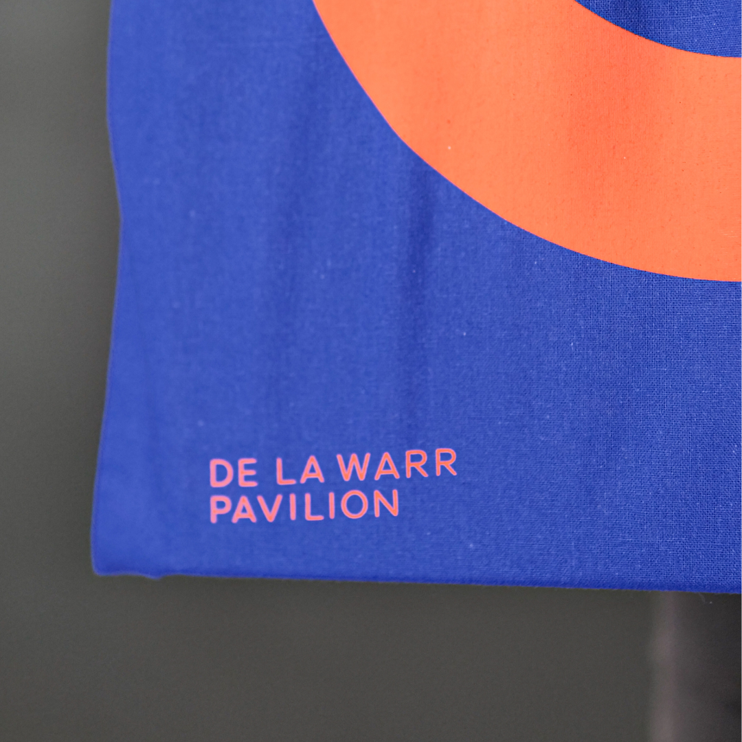 Close up of Canvas shopping bag in royal blue with a large orange DLWP roundel