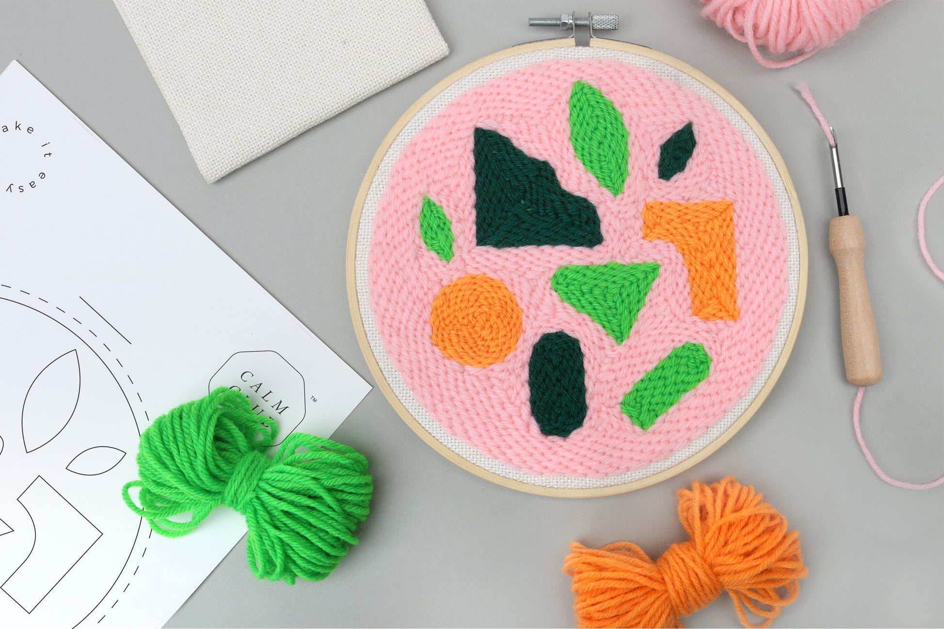 completed punch needle kit with tools surrounding