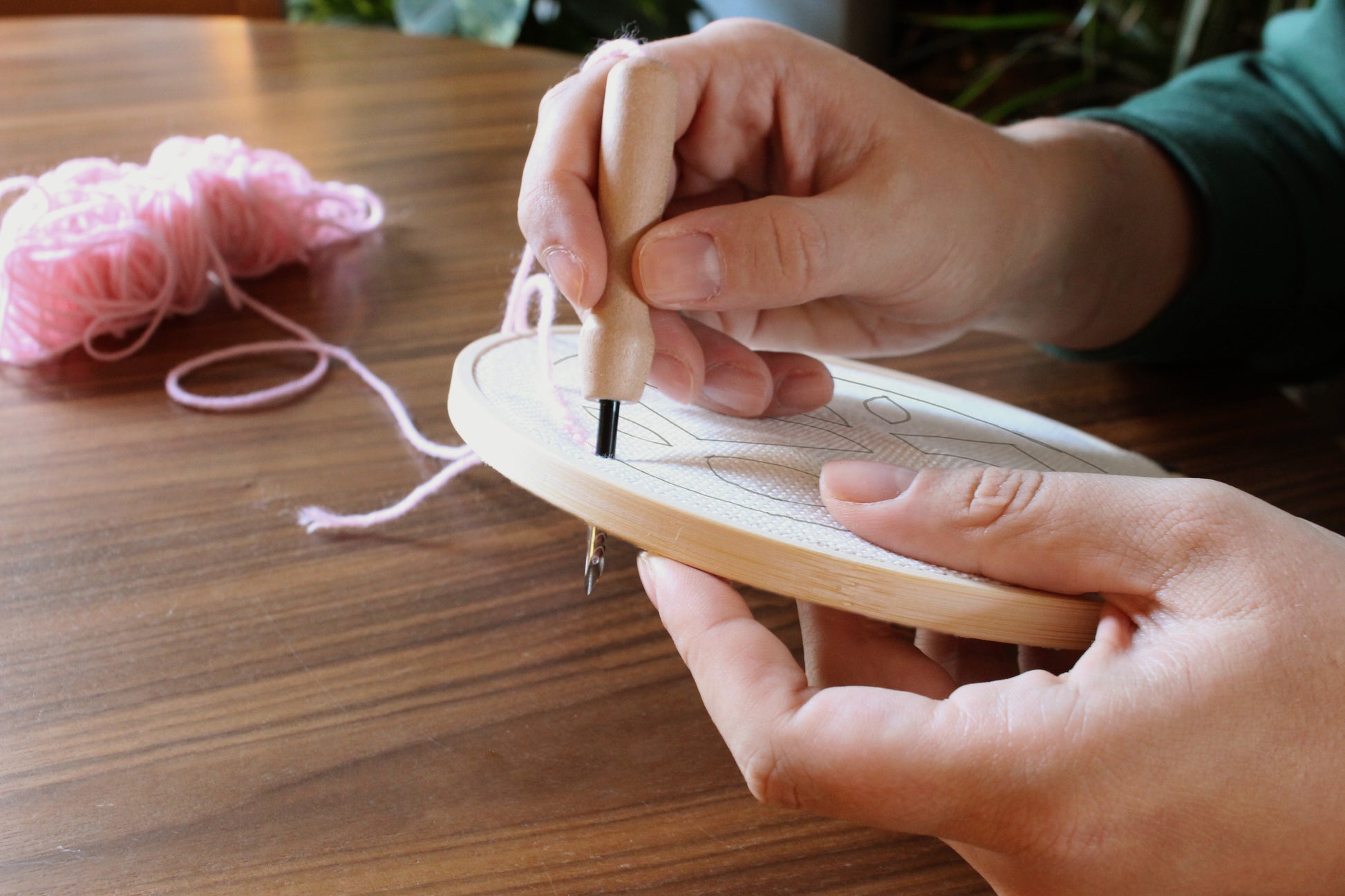 someone using the punch needle