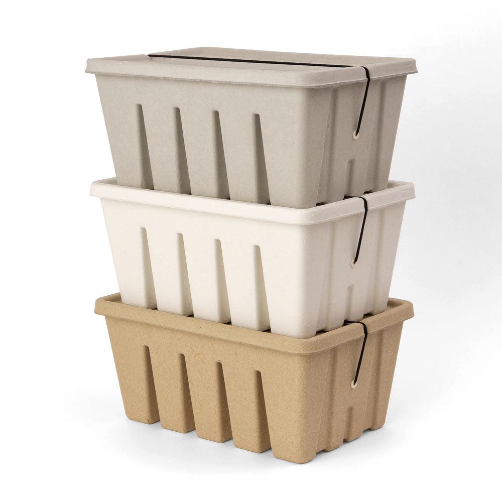 three storage boxes made of paper stacked on top of each other in white, grey, and beige