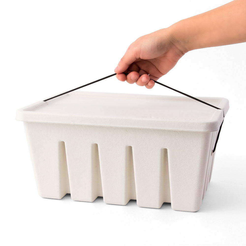 closed white storage box made of paper secured by a black rubber band