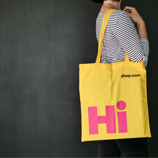Bright yellow tote bag with the word 'Hi' in large pink font