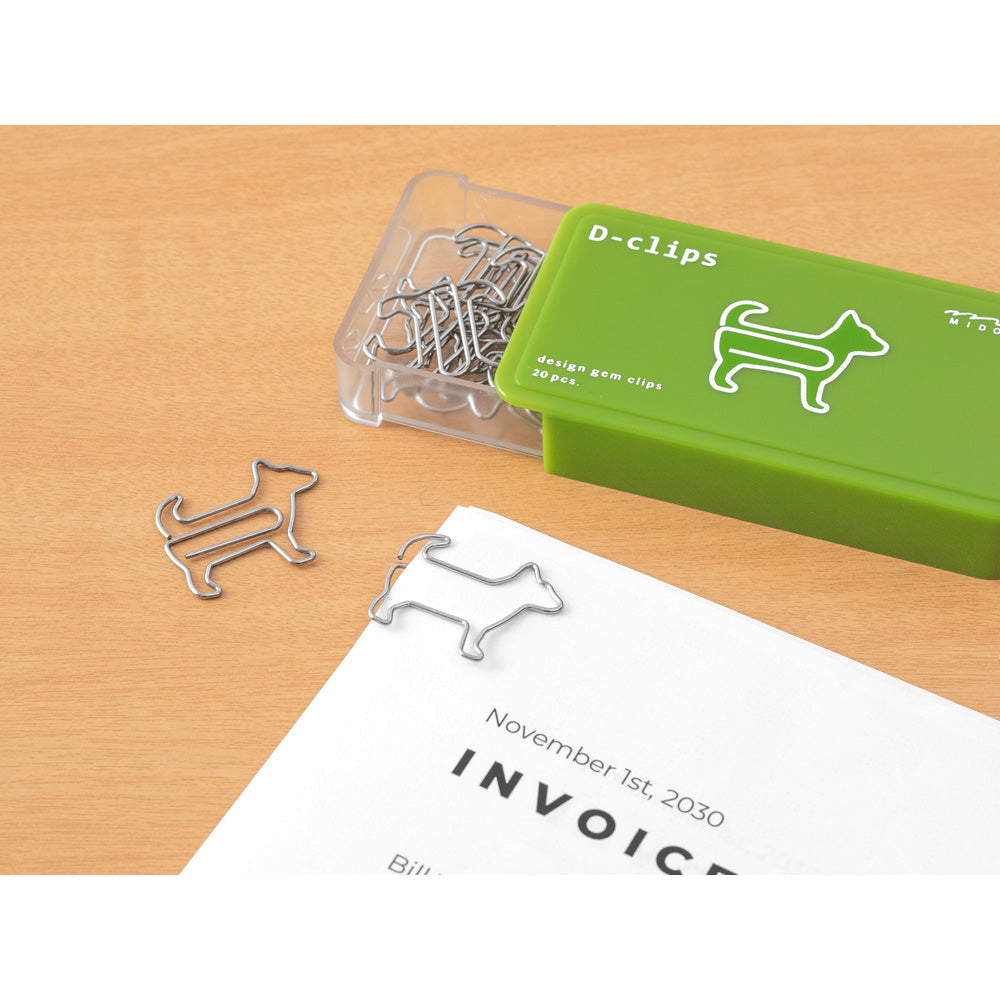 Dog shaped paper clips in a slide open green box. A paper clip is being used on an invoice.