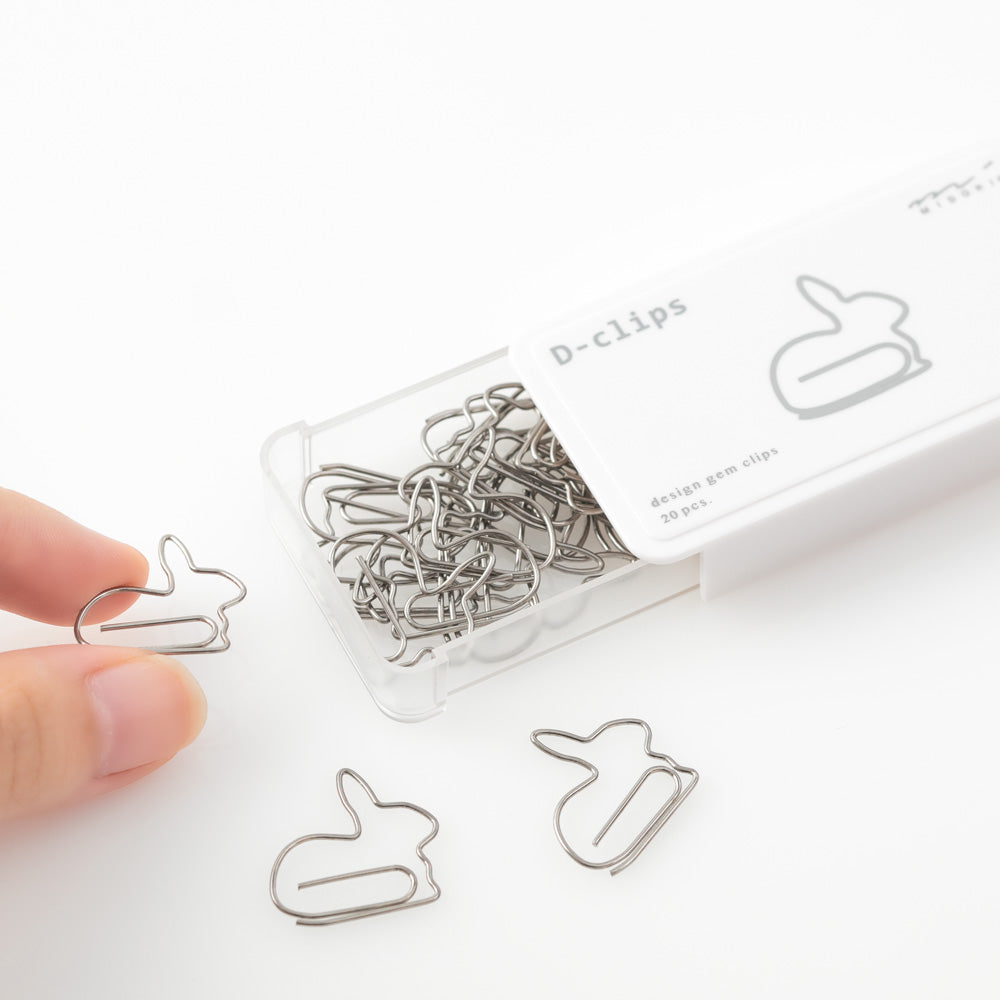 Rabbit shaped paper clips in slide-open white box.