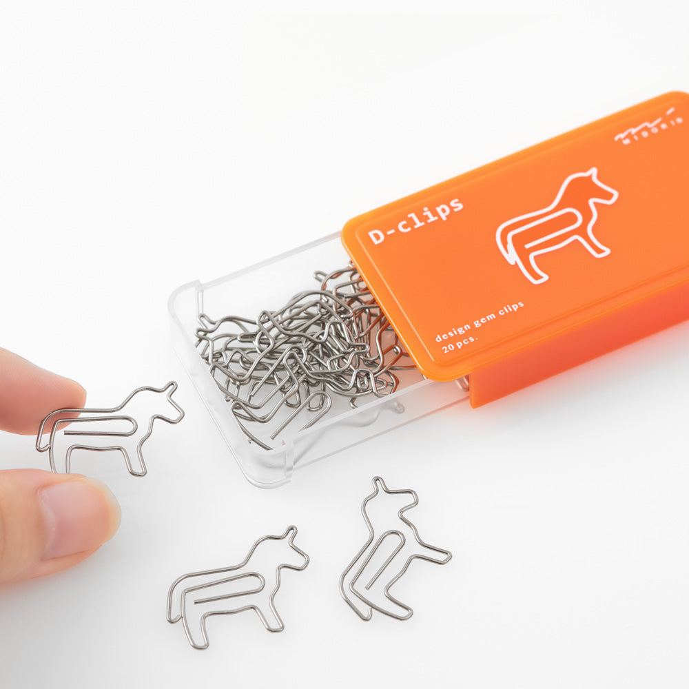 Horse shaped paper clips in slide-open orange box.