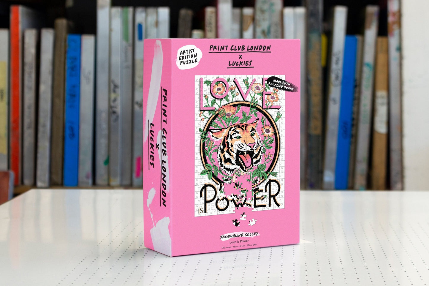 Box of jigsaw puzzle with illustration of a tiger and words 'Love is Power'. 