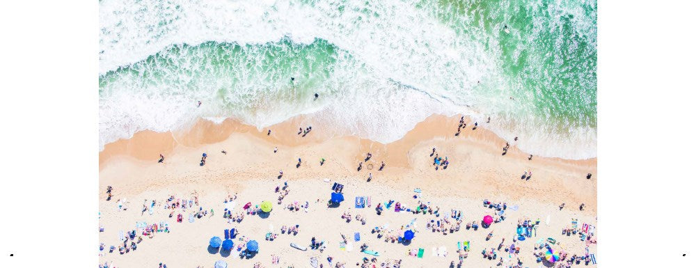 page of Coastal by Gray Malin with photograph of people on the beach and sea