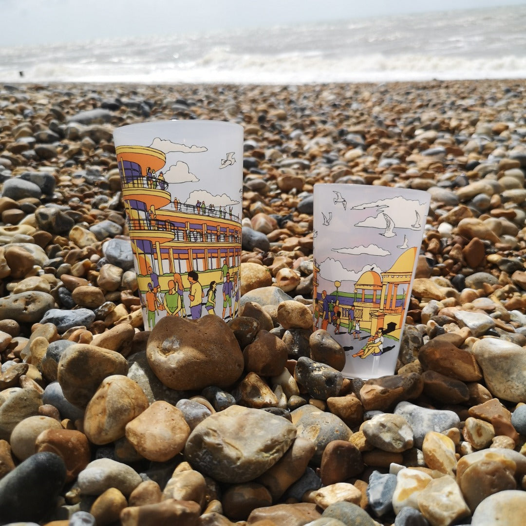 Two plastic cups with illustration of De La Warr Pavilion on the beach