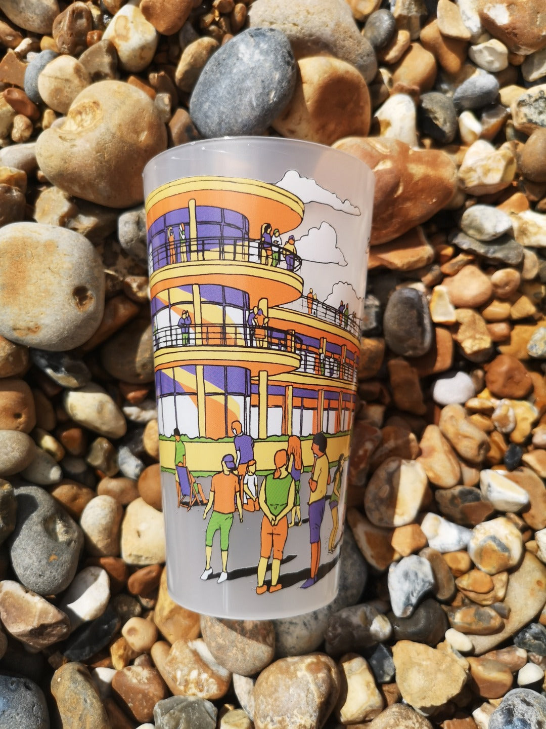 Reusable plastic pint cup with illustration of De La Warr Pavilion on the beach.