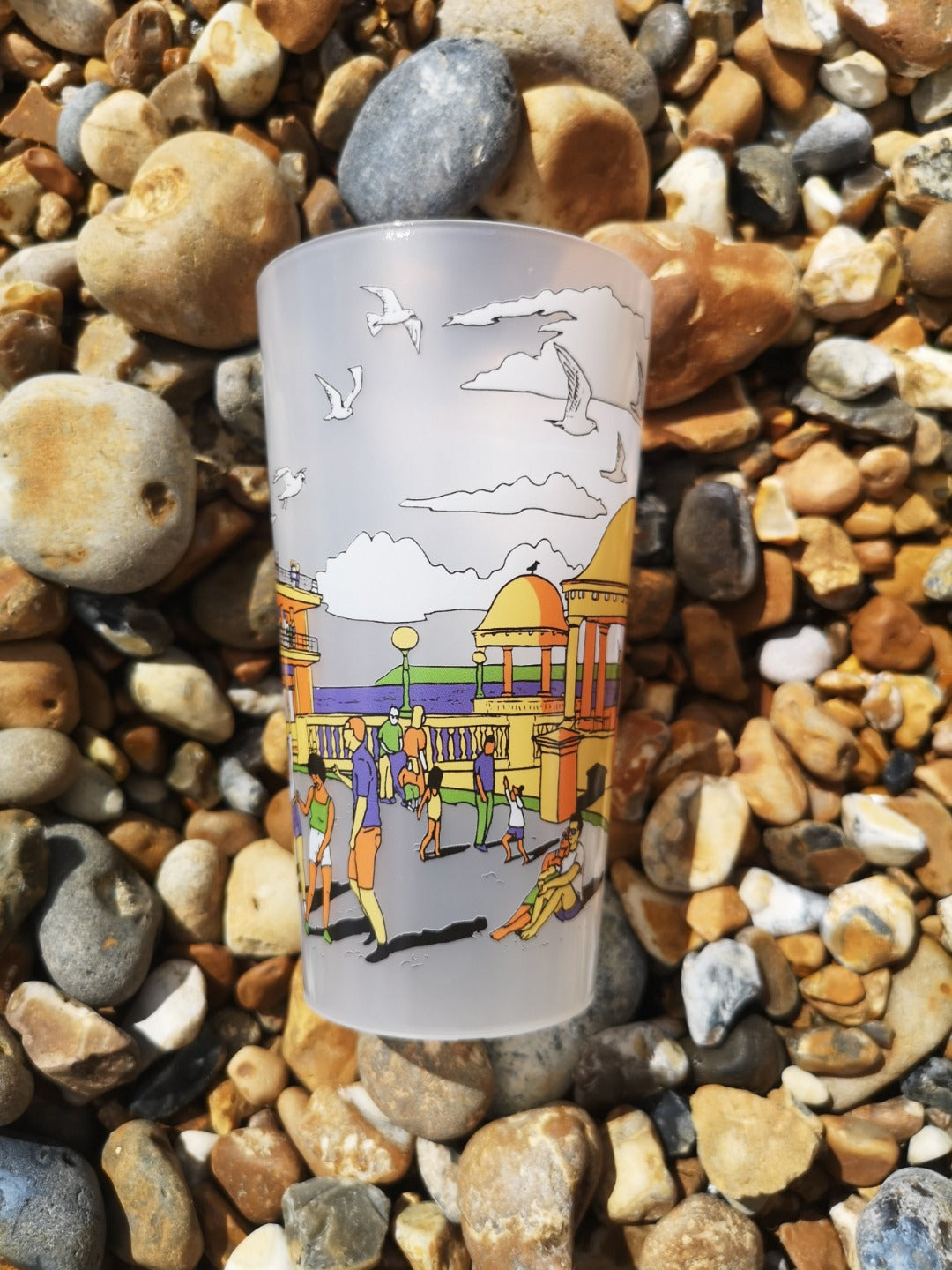 Reusable plastic pint cup with illustration of De La Warr Pavilion on the beach.