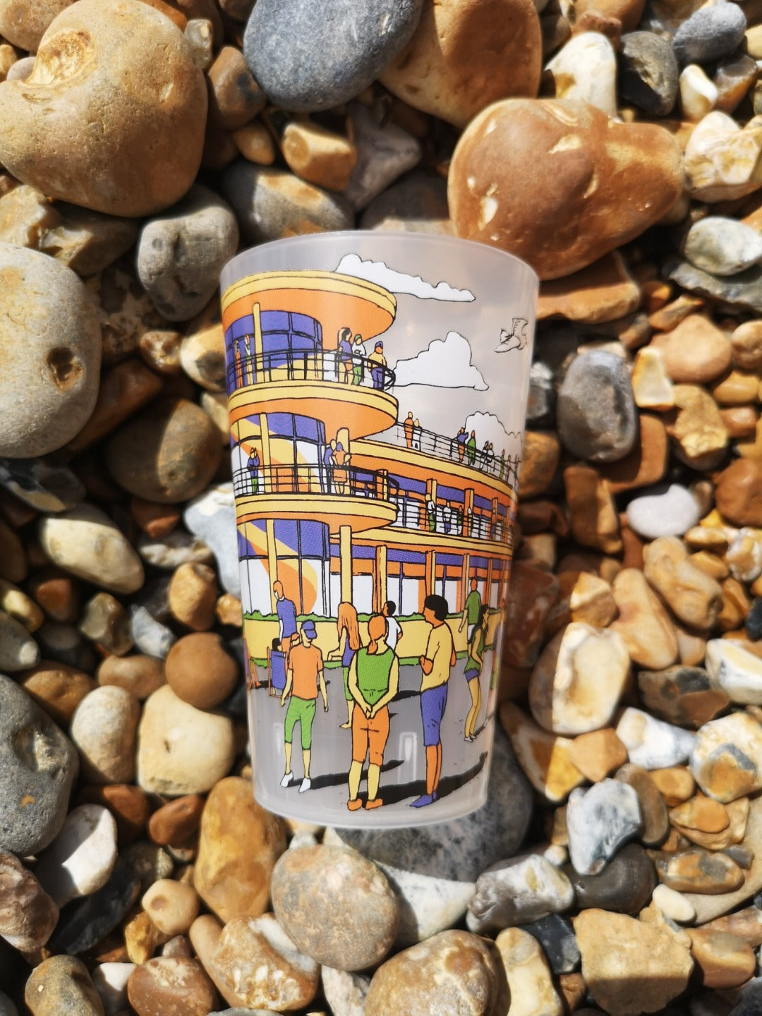 Reusable plastic half pint cup with illustration of De La Warr Pavilion on the beach.