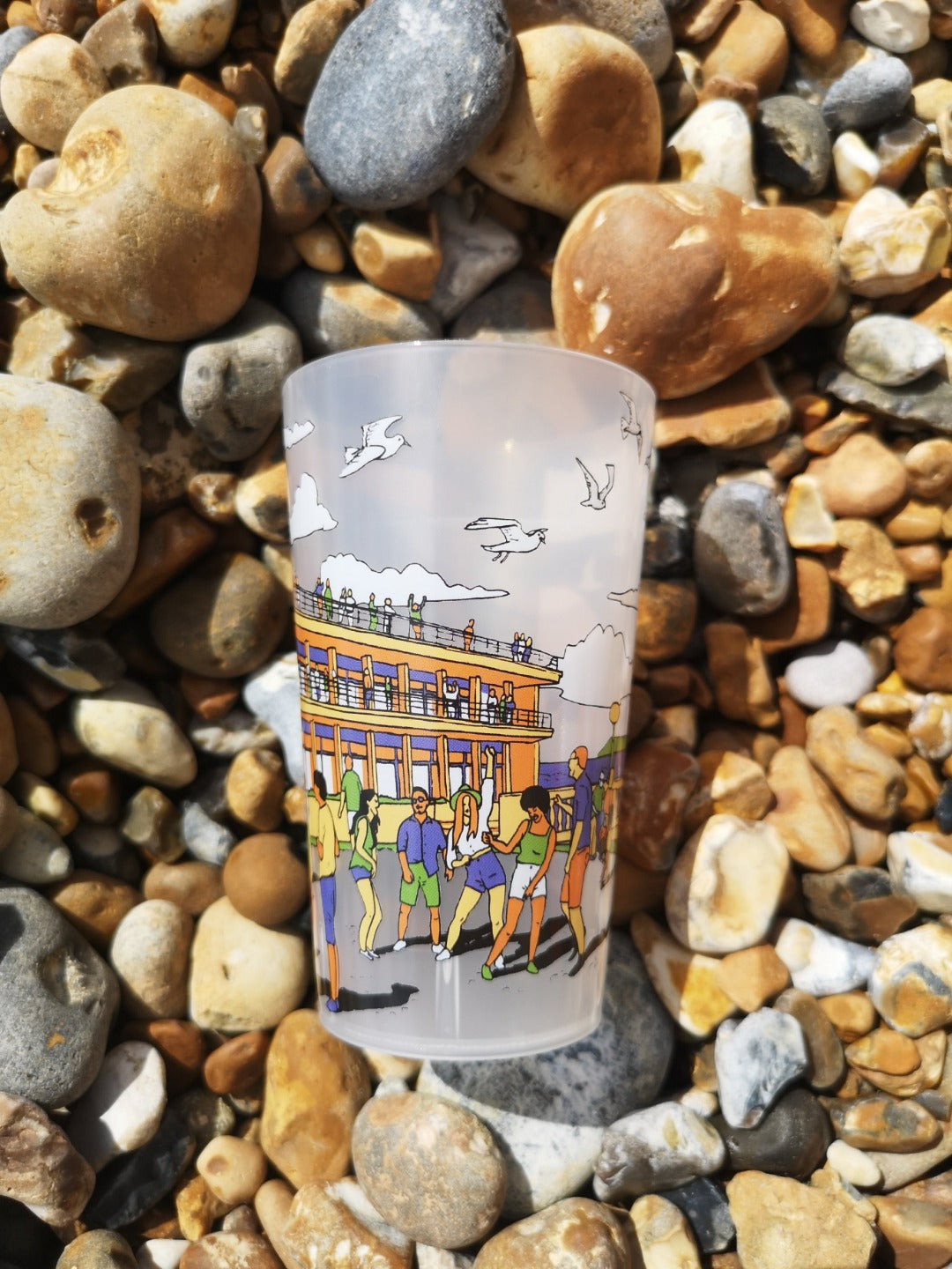 Reusable plastic half pint cup with illustration of De La Warr Pavilion on the beach.