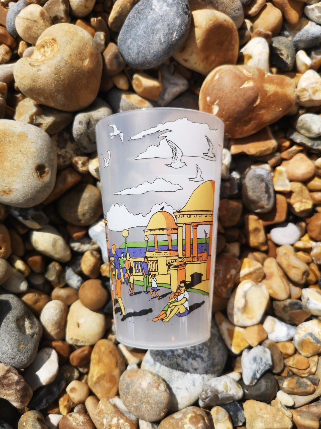 Reusable plastic half pint cup with illustration of De La Warr Pavilion on the beach.