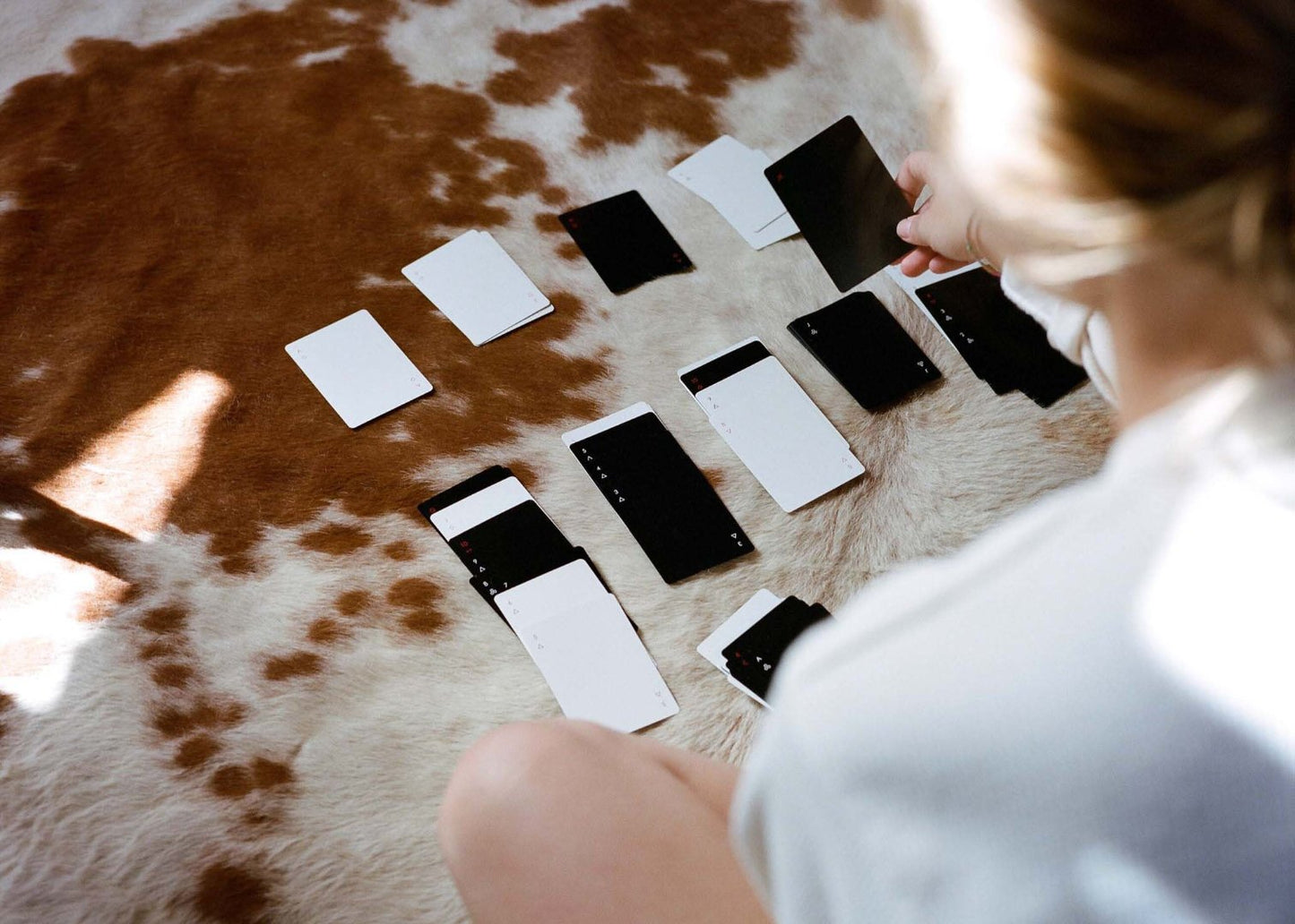 someone playing a game with minimalist black and white playing cards