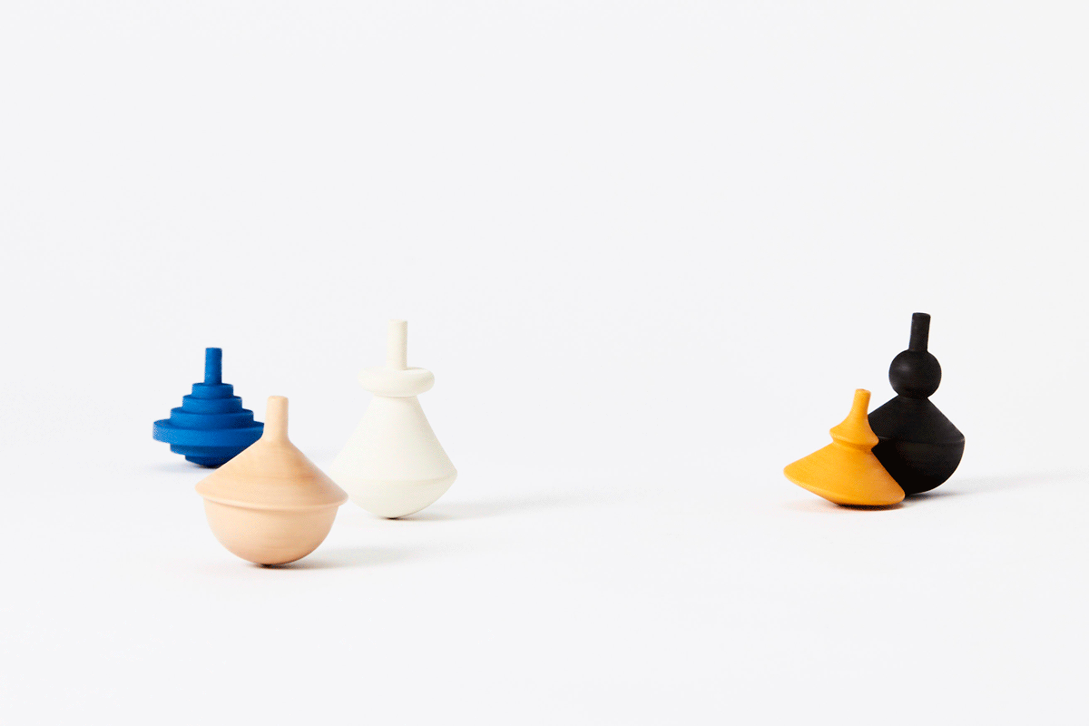 gif of 5 wooden spinning tops spinning