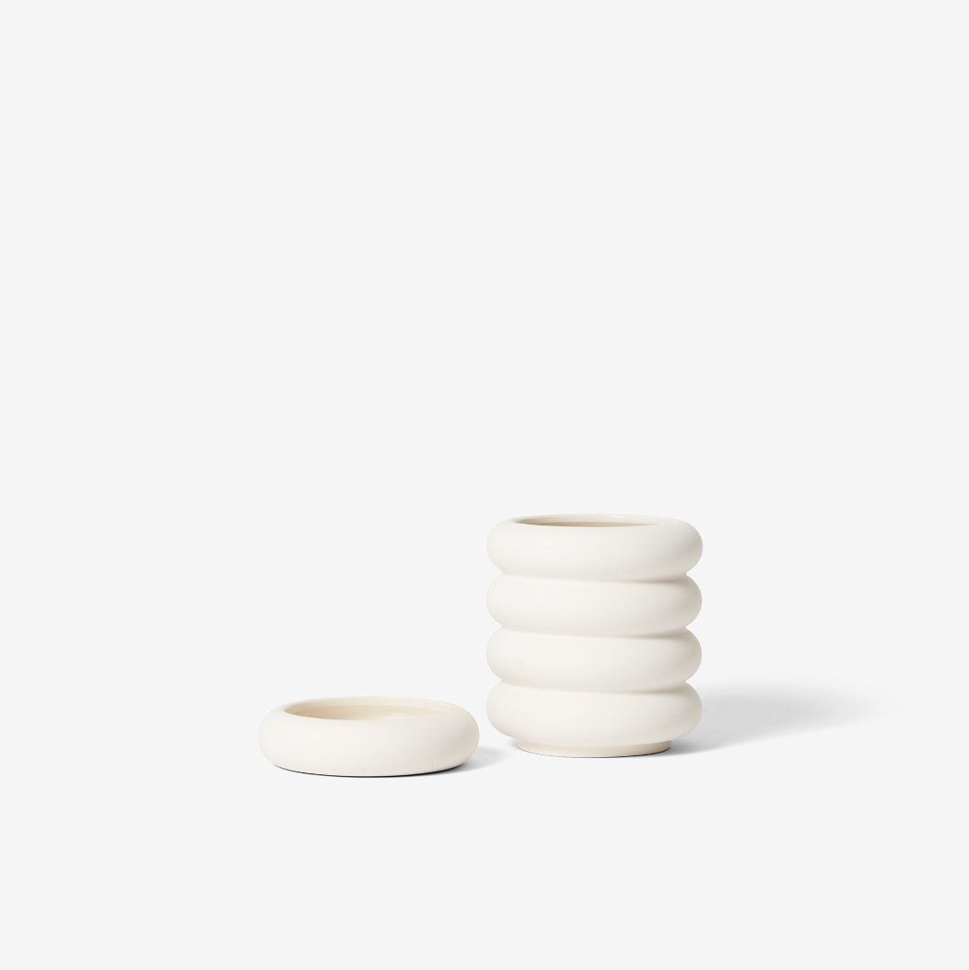 white rounded planter and bottom dish