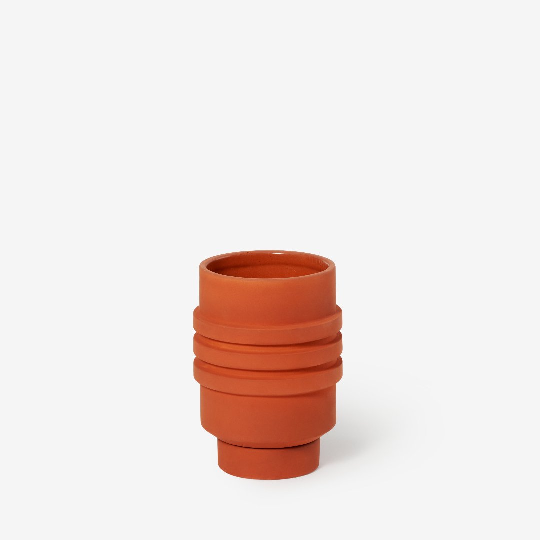 Green plant pot with sculptural ridges and shape, and a glazed inside.