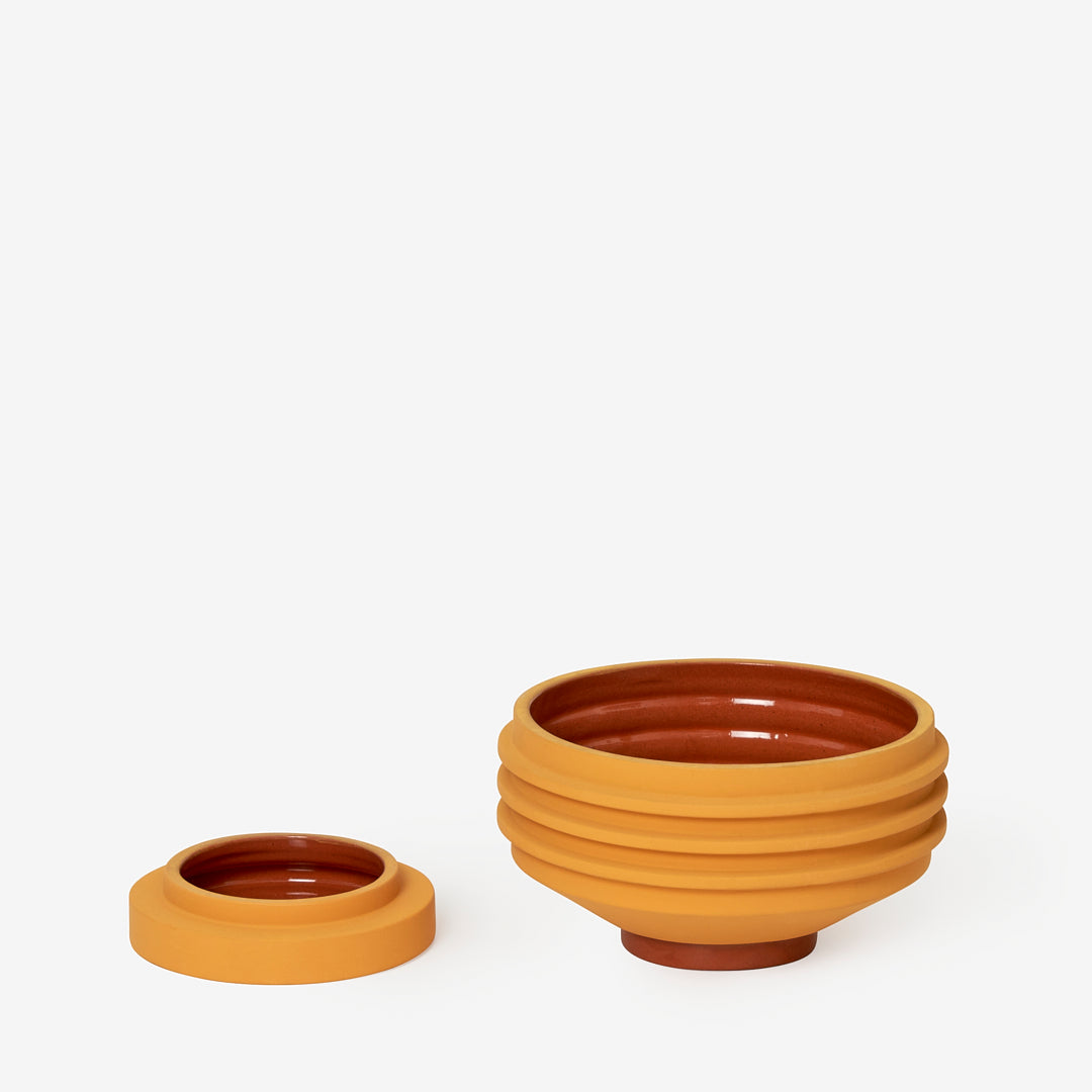 Yellow plant pot with sculptural ridges and shape, and it's dish/base in the same colour. The inside is glazed terracotta.