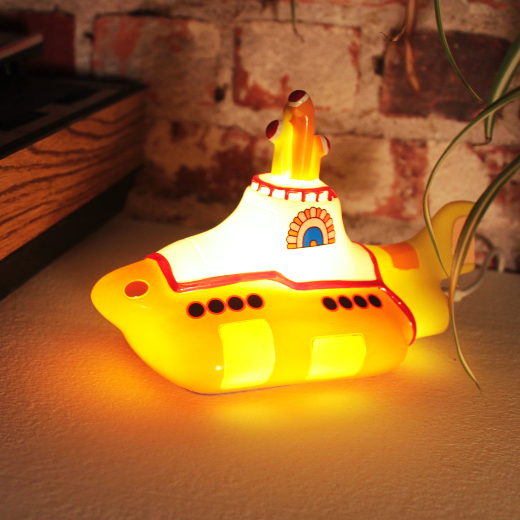 The Beatles Yellow Submarine lamp, with a warm yellow glow