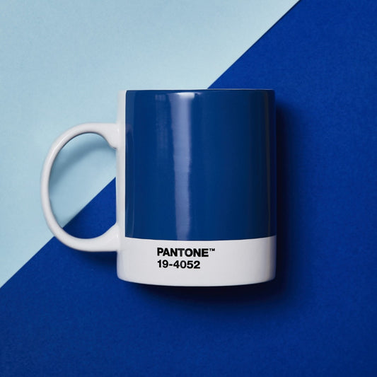 Pantone mug, blue with white handle and base. Text on white lower part reads 'PANTONE TM 19-4052'