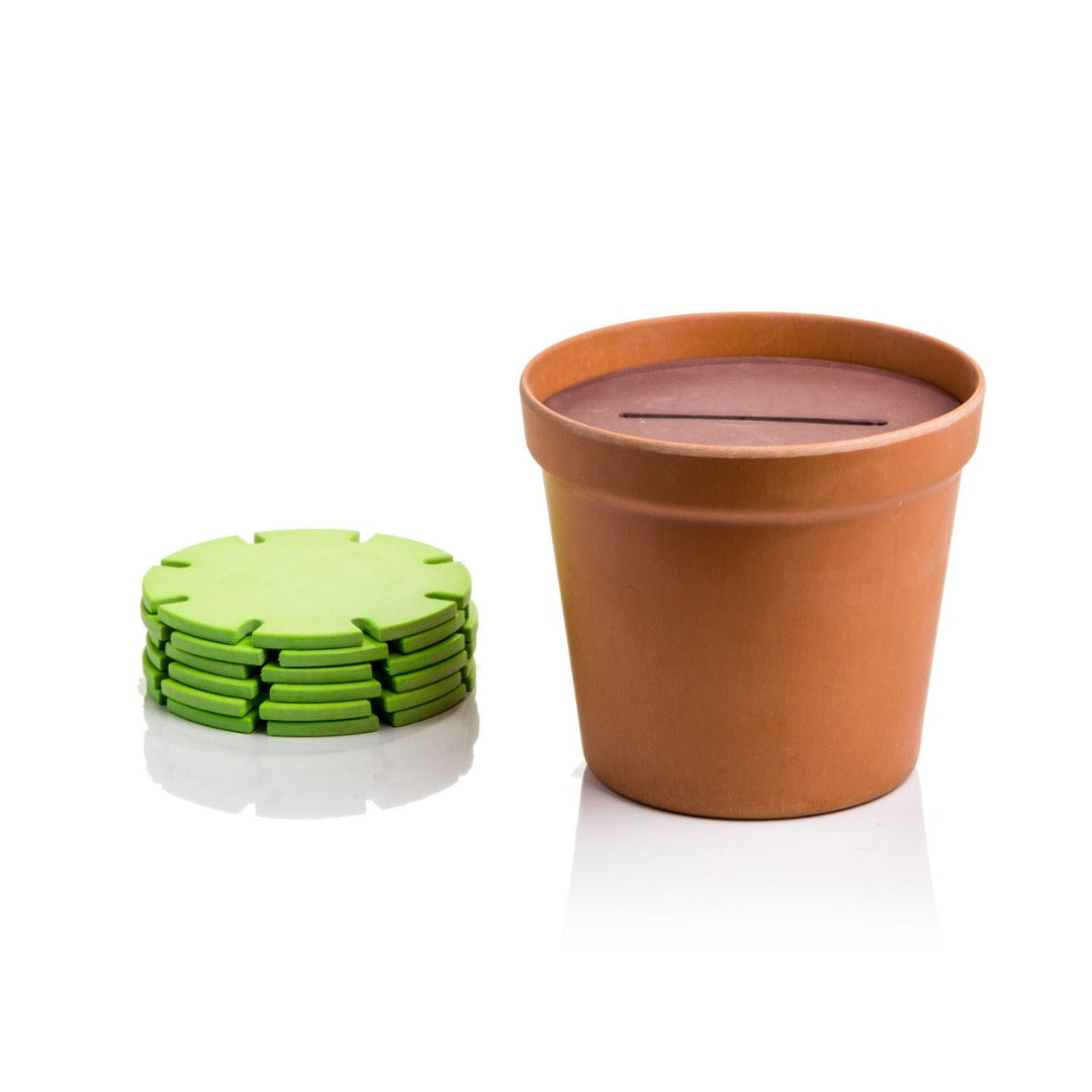 green coasters stacked next to storage pot that resembles a plant pot