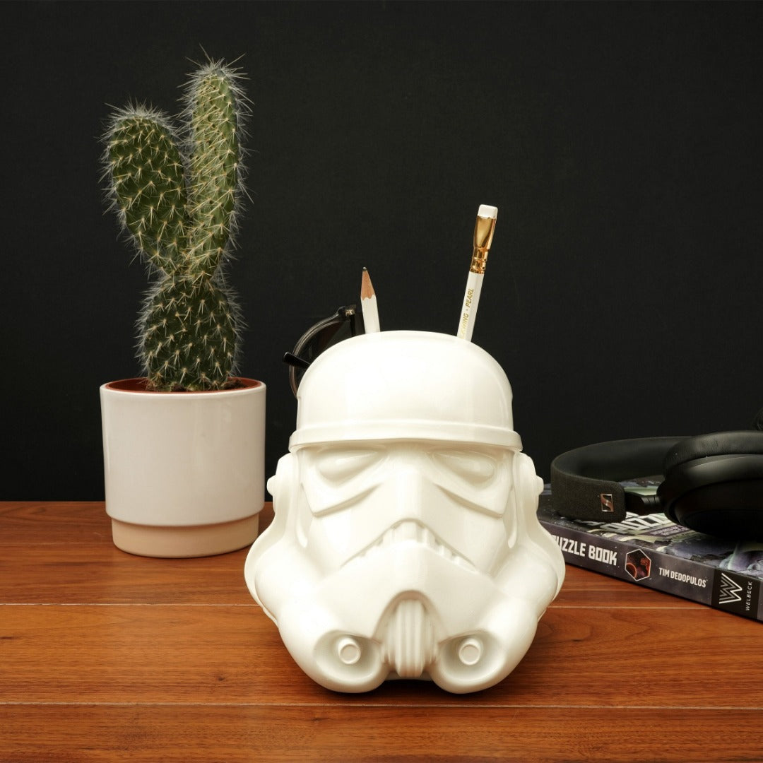desk tidy shaped like a Stormtrooper helmet on a desk with glasses and pencils stored in it